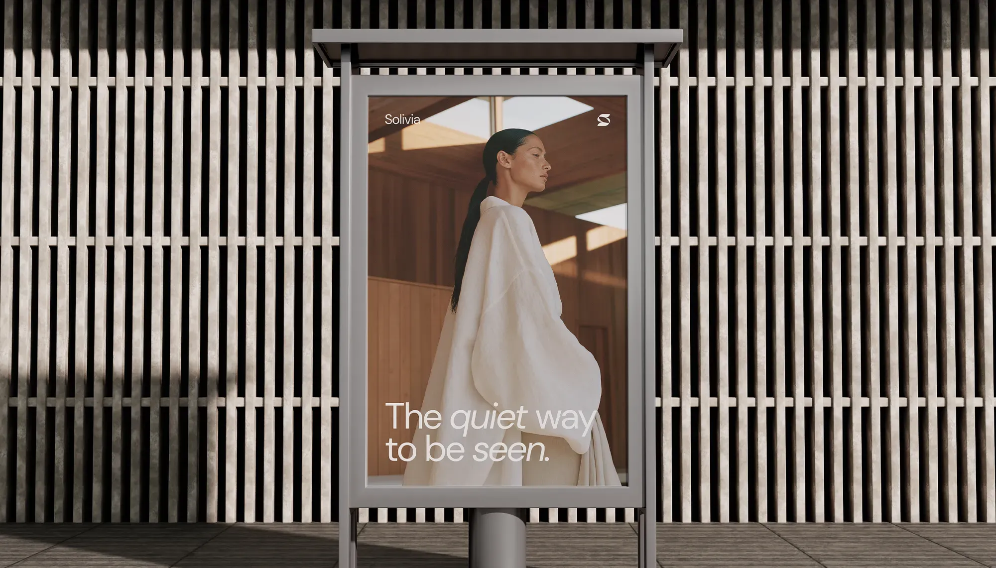 Solivia street billboard reading 'The quiet way to be seen' with a model in flowing white linen